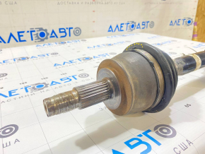 The front right drive axle shaft of a Jeep Renegade 15-21 2.4 AWD has a torn boot.