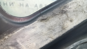 The rear right underbody protection of the Audi A5 F5 18-25 is pressed, worn, and cracked.