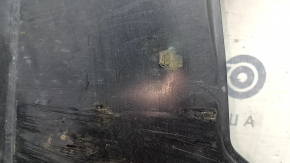The rear right underbody protection of the Audi A5 F5 18-25 is pressed, worn, and cracked.