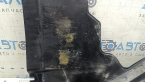 The rear right underbody protection of the Audi A5 F5 18-25 is pressed, worn, and cracked.