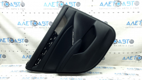 The rear left door panel of a 2018 Honda Accord is black, with a black leather insert. The armrest is black leather, the molding has a black texture, and there are scratches.