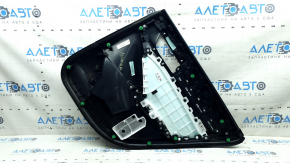 The rear left door panel of a 2018 Honda Accord is black, with a black leather insert. The armrest is black leather, the molding has a black texture, and there are scratches.