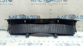 The Audi A4 B9 17-20 trunk opening trim is black, worn, and the mount is broken.