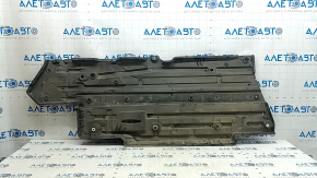 The left underbody protection of a Toyota Camry v70 18-24 is dented and torn.