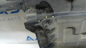 The left underbody protection of a Toyota Camry v70 18-24 is dented and torn.