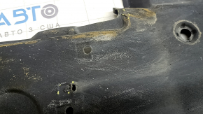 The left underbody protection of a Toyota Camry v70 18-24 is dented and torn.