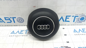 The steering wheel airbag for the driver's side of the Audi A6 C7 12-18 is black and scratched.