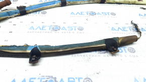 The left side curtain airbag of a BMW 3 G20 19-26 is covered in soot and has a rusty squib.