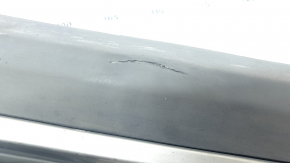 The lower front left door trim for a Lincoln Corsair 20-26 is dented and torn.
