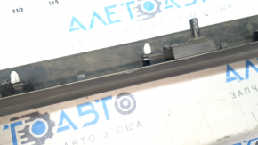 The lower front left door trim for a Lincoln Corsair 20-26 is dented and torn.
