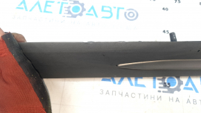 The lower front left door trim for a Lincoln Corsair 20-26 is dented and torn.