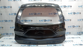 The trunk door of a Toyota Venza 21-24 is dented.