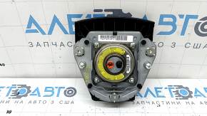 The airbag in the driver's steering wheel of a Toyota Prius 30 10-15 is black, scratched, worn, and the chrome is peeling.