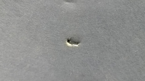 Jeep Grand Cherokee WL 21-26 hood insulation is torn and dented.