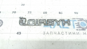 Emblem with the inscription "Hybrid" on the front right fender of a Toyota Rav4 16-18