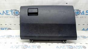 The glove compartment of a Toyota Rav4 2013-2018 is black and has scratches.