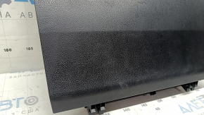 The glove compartment of a Toyota Rav4 2013-2018 is black and has scratches.