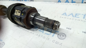 The front left half-shaft of a Toyota Rav4 16-18 hybrid is rusty and has a torn inner boot.