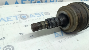 The front left half-shaft of a Toyota Rav4 16-18 hybrid is rusty and has a torn inner boot.