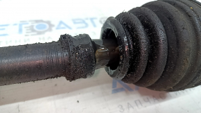 The front left half-shaft of a Toyota Rav4 16-18 hybrid is rusty and has a torn inner boot.