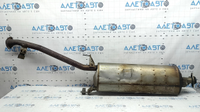 The exhaust pipe, middle section of a 1998 Toyota Rav4 hybrid, is rusty, dented, and has a broken stud.