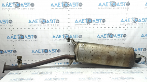 The exhaust pipe, middle section of a 1998 Toyota Rav4 hybrid, is rusty, dented, and has a broken stud.