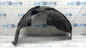 The rear left fender liner of a Kia Sportage 23-26 is dented and torn.