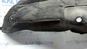 The rear left fender liner of a Kia Sportage 23-26 is dented and torn.