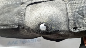 The rear left fender liner of a Kia Sportage 23-26 is dented and torn.
