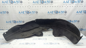 The rear left fender liner of a Kia Sportage 23-26 is dented and torn.