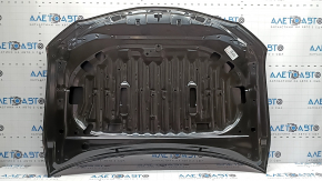 The hood of a Toyota Camry V70 18-24 aluminum is bare. The corner is bent.