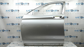 The front left door of an Infiniti QX50 19-25 silver K23 is bare, dents, and the sealant has peeled off.