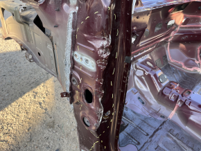 Front left quarter panel of a 19-24 Ford Edge on the body, burgundy, rusty, torn