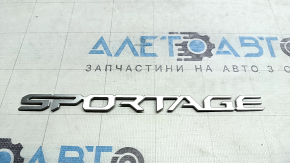 The SPORTAGE emblem on the Kia Sportage 23-26 trunk door