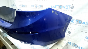 The rear bumper is bare for a Honda Insight 19-22 blue, 593M, dented, cracked, and the mount is broken.