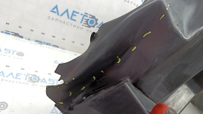 The rear right fender liner of a 19-23 Jeep Renegade is dented and the fastener is torn.