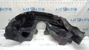The rear right fender liner of a 19-23 Jeep Renegade is dented and the fastener is torn.