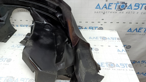 The rear right fender liner of a 19-23 Jeep Renegade is dented and the fastener is torn.