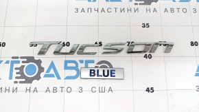 The Tucson Blue emblem is on the tailgate of the Hyundai Tucson 2022-2026.