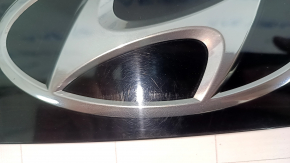 The Hyundai Tucson 2022-26 tailgate emblem is worn.
