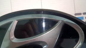 The Hyundai Tucson 2022-26 tailgate emblem is worn.