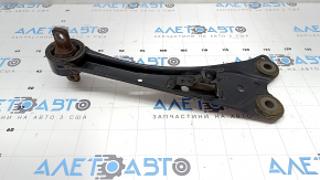 The rear right longitudinal control arm of a Lexus CT200h 11-17 has a cracked silent block.