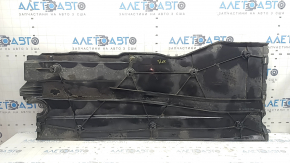 Left underbody protection for VW Jetta 19-26 is worn, dented, and the fastening is broken.