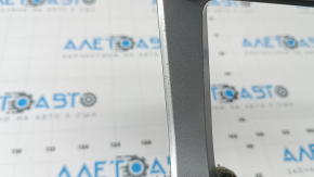 The center console trim for the Audi Q3 83A 19-25 is gray and has scratches and peeling paint.