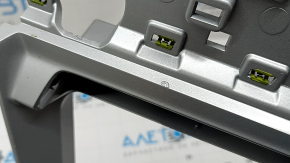 The center console trim for the Audi Q3 83A 19-25 is gray and has scratches and peeling paint.