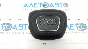 The Audi Q3 83A 19-25 steering wheel airbag is black, with peeling chrome and scratches.