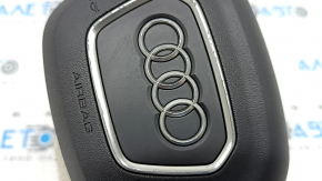 The Audi Q3 83A 19-25 steering wheel airbag is black, with peeling chrome and scratches.