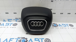 The Audi Q7 2020-2026 driver's steering wheel airbag is black and scratched.