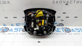 The Audi Q7 2020-2026 driver's steering wheel airbag is black and scratched.
