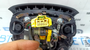 The Audi Q7 2020-2026 driver's steering wheel airbag is black and scratched.